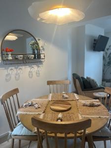 a dining room with a table with chairs and a mirror at 31 Lower English in Armagh