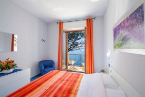 a bedroom with a bed and a large window at Calipso Residence in Furore