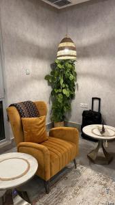 a living room with a couch and a chair and tables at Luxury B3 Chalet COMO in Al Khīrān