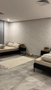 a room with two beds and a wall at Luxury B3 Chalet COMO in Al Khīrān