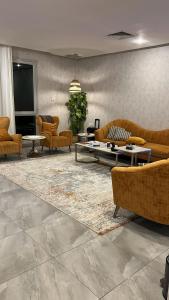 a living room with couches and tables on a rug at Luxury B3 Chalet COMO in Al Khīrān
