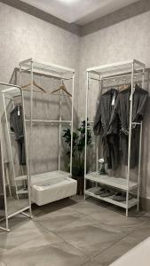 a room with two racks of clothes at Luxury B3 Chalet COMO in Al Khīrān +25 photos