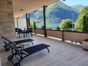 a balcony with a view of a lake and mountains at La Rosa di Ilde in Porlezza