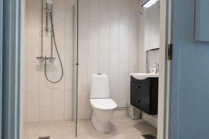 a bathroom with a shower and a toilet and a sink at Nord Heaven in Turku