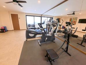 a gym with several treadmills and cardio machines at Grand Fifty Suites in Playa del Carmen