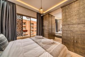 a bedroom with a large bed in a room at Prime location Moroccan-Style Luxury Apartment with Parking near Carré Eden Shopping Center in Marrakesh