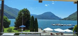 a view of a lake with boats in the water at La Rosa di Ilde in Porlezza