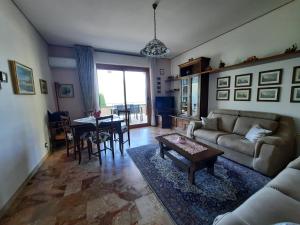 a living room with a couch and a table at La Rosa di Ilde in Porlezza +36 photos