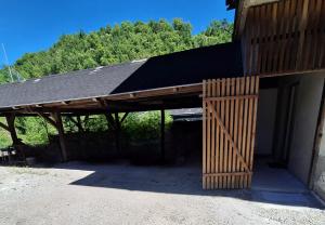 a barn with a wooden door on the side of it at CozyNest in Kamna Gorica +2 photos