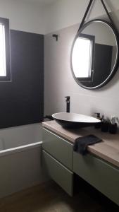 a bathroom with a sink and a mirror at Le Mans Changé GP 24H DU MANS in Changé