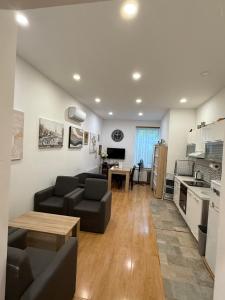 a living room with a couch and a table at Rooms Gollner in Zagreb