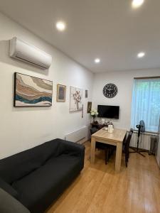 a living room with a couch and a table at Rooms Gollner in Zagreb
