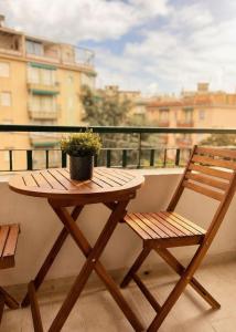 a wooden table and a chair on a balcony at Riva Viola in Alassio