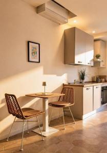 a kitchen with a table and chairs in a room at Riva Viola in Alassio
