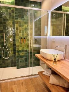 a bathroom with a sink and a glass shower at Riva Viola in Alassio +21 photos