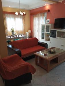a living room with a couch and a table at mastic flavored sweet in Chios