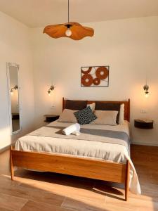 a bedroom with a large bed with a ceiling at Riva Viola in Alassio