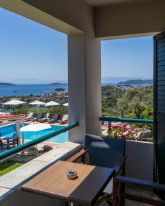a balcony with a table and a view of the ocean at Vigles Sea View, Philian Hotels and Resorts in Skiathos