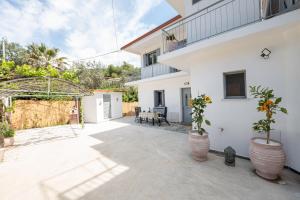 a courtyard of a house with potted plants at Luxury Villa Yvonni in Poros