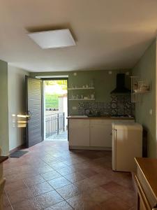 a kitchen with a refrigerator and a door to a patio at Casa Tritapepe in Torricella Peligna
