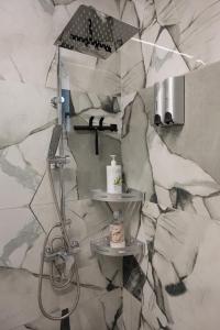 a shower in a bathroom with a marble wall at Luxury Villa Yvonni in Poros +40 photos