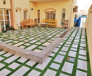 a patio with a table and chairs on it at Home Line in Doha