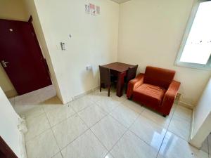 an empty room with a chair and a table at Home Line in Doha +6 photos