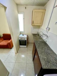 a kitchen with a stove and a counter top at Home Line in Doha