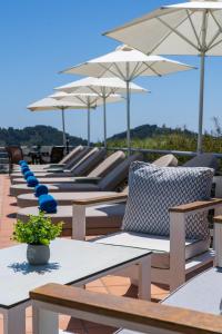 a row of chairs and umbrellas on a deck at Vigles Sea View, Philian Hotels and Resorts in Skiathos