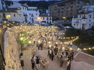 a group of people walking around a courtyard with lights at Casa Bajo Castillo in Montán