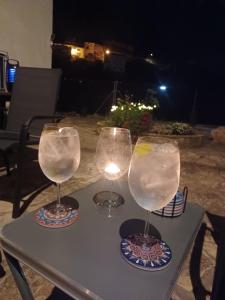 two wine glasses sitting on top of a table at Casa Bajo Castillo in Montán
