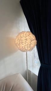 a lamp sitting next to a window next to a curtain at THHPSOCIETY - Taha Cottages in Bhīm Tāl