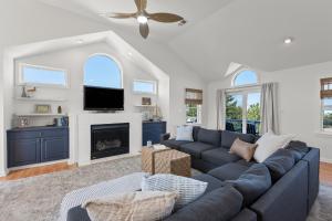 a living room with a blue couch and a fireplace at Dune Deck in Corolla