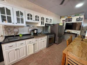 a kitchen with white cabinets and stainless steel appliances at Apartment Nazareth in La Unión