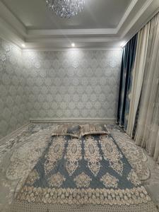 a bedroom with a bed with a chandelier at Starpath Homestay in At-Bashy +5 photos
