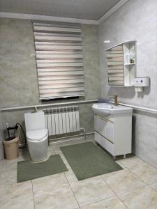 a bathroom with a toilet and a sink at Starpath Homestay in At-Bashy