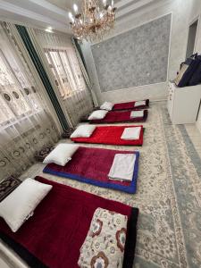 a group of four beds in a room at Starpath Homestay in At-Bashy