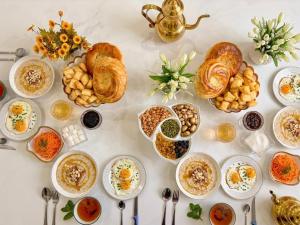 a table topped with lots of dishes of breakfast foods at Starpath Homestay in At-Bashy