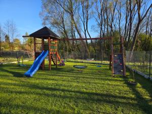 a playground with a slide and a slideintend at Zacisze na Roztoczu in Horyniec
