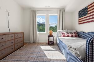 a bedroom with a bed and an american flag on the wall at Dune Deck in Corolla +68 photos