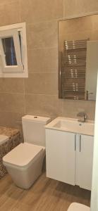 a bathroom with a toilet and a sink at Lilli's House in Kassiopi +19 photos