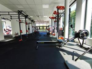 a gym with a treadmill and weights in a room at Wioska Indiańska River Park Zator SPA RESORT in Zator