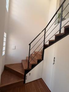 a staircase in a house with wooden floors and a window at APART-Esperanza in Esperanza +1 photo