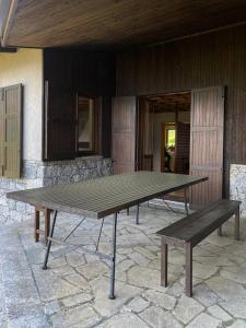a picnic table with a bench in front of a building at Chalet il pino in San Bernardo