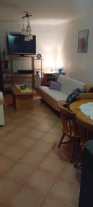 a living room with a couch and a tv at Vila Sofija in Vinci