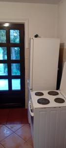 a kitchen with a white stove and a refrigerator at Vila Sofija in Vinci