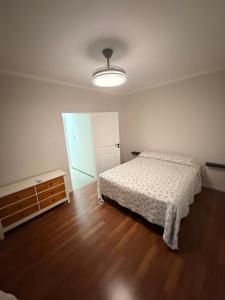 a bedroom with a bed and a wooden floor at APART-Esperanza in Esperanza