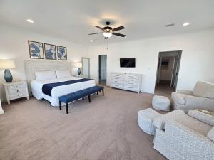 a large bedroom with a bed and a couch at New Home 3br/25br w/ kayak access sleeps 9 in Orange Beach