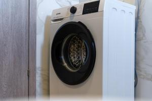 a white washing machine sitting in a room at ElGio Maisonette Nikiti in Nikiti