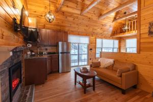 a living room with a couch and a fireplace at Presidential Mountain Resort in Bethlehem